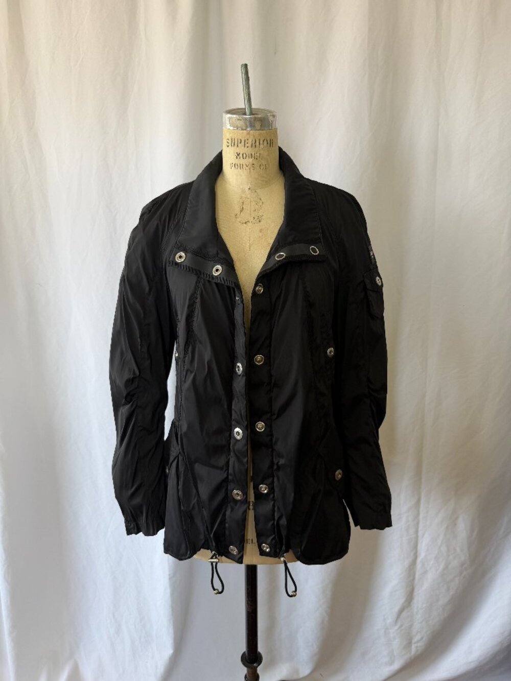 Black multifunction jacket with a packable bag